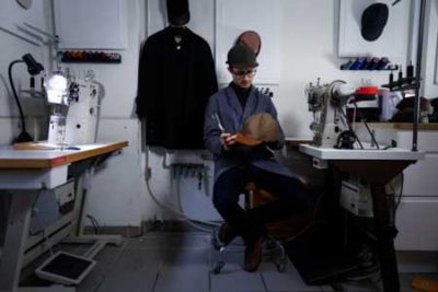 Silas sitting in the hat shop